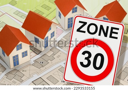 From dangerous road for cars to safe road for people - concept with zone 30 road sign, imaginary city map and residential buildings areas Royalty-Free Stock Photo #2293533155