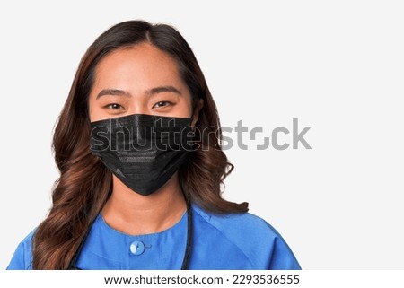 Masked young chinese female nurse.
