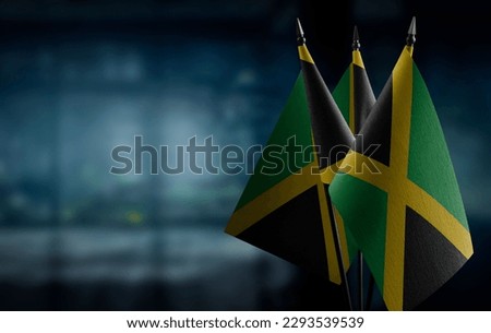 Small flags of the Jamaica on an abstract blurry background.