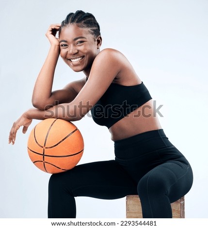 Ive been balling all day. Studio shot of a sporty young woman posing with a basketball against a studio background.