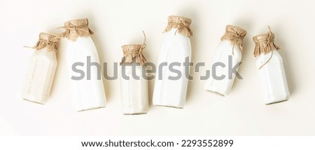 Vegan non dairy plant based milk in bottles on light background banner. Alternative lactose free milk substitute. Top view Royalty-Free Stock Photo #2293552899