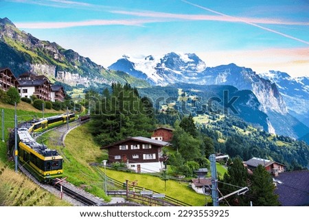 Beautiful mountain landscape with train in canyon of the city Lauterbrunnen in the Swiss Alps, Switzerland. Amazing places. Royalty-Free Stock Photo #2293553925