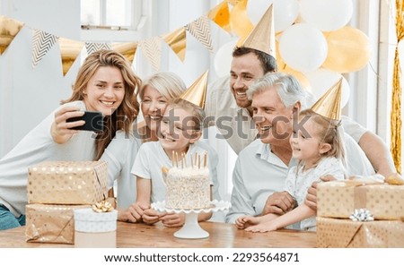 Being together is the best birthday gift ever. Shot of a happy family taking selfies while celebrating a birthday at home.