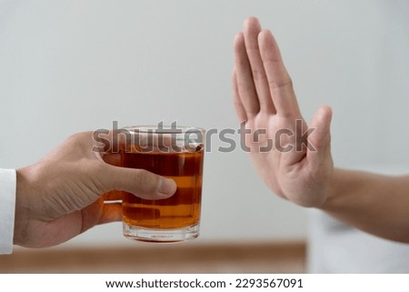 man refuses say no and avoid to drink an alcohol whiskey , stopping hand sign male, alcoholism treatment, alcohol addiction, quit booze, Stop Drinking Alcohol. Refuse Glass liquor, unhealthy, reject Royalty-Free Stock Photo #2293567091