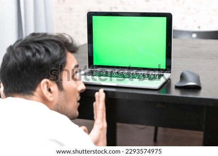 Back view on shocked man working on laptop. Green Screen and space for text concept	