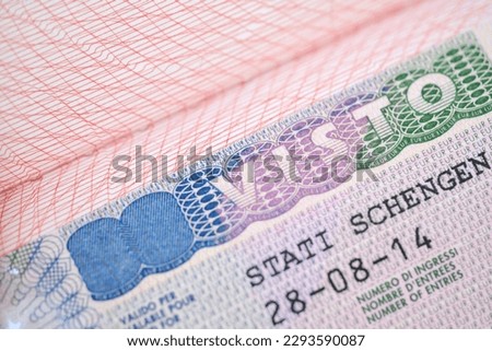 close-up page of document, foreign passport for travel with European italian visa, tourist schengen visa stamp with hologram with shallow depth of field, passport control at border, travel in Europe