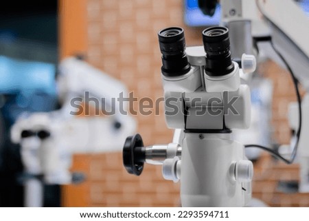 Professional medical microscope in scientific laboratory: close up, selective focus. Medicine, technology, laboratory concept
