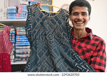 Portrait of an Indian shopkeeper at his shop