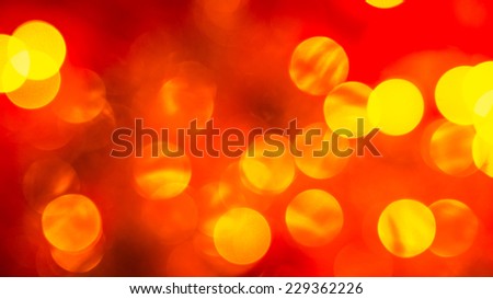 abstract red blurred background with golden bright circles