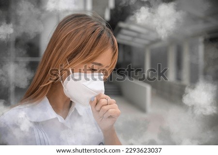 Asian woman wear N95 mask for protect dust pm 2.5,ecology concept. Allergy, headache. air danger in city. Royalty-Free Stock Photo #2293623037