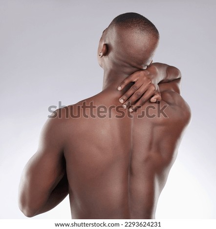 I cant find the pain. Shot of an unrecognisable man standing alone in the studio and suffering from an upper back injury. Royalty-Free Stock Photo #2293624231