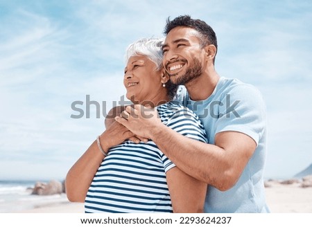 I will love you forever and a day. Shot of a young man spending the day at the beach with his elderly mother. Royalty-Free Stock Photo #2293624237