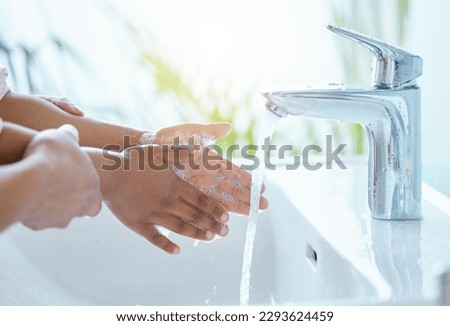 Teaching her good hygiene habits. Shot of an unrecognizable parent helping their child wash their hands at home. Royalty-Free Stock Photo #2293624459