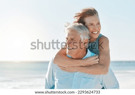 Were having a lovely day at the beach. Shot of a mature couple spending time together at the beach. Royalty-Free Stock Photo #2293624733