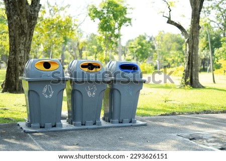 Recycling bins in the park. Outdoor garbage containers for plastic, paper, glass. Waste separation rubbish to garbage bin, environment care pollution trash recycling. Sustainable lifestyle concept. Royalty-Free Stock Photo #2293626151