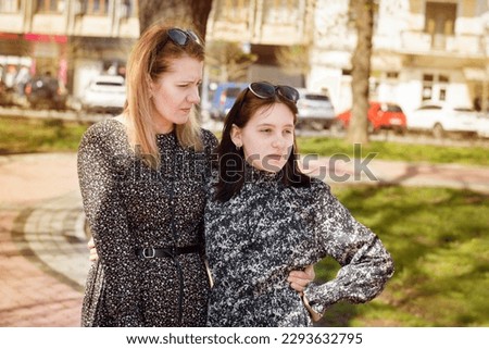 Difficult relations between parents and children, teenagers. Woman tries to communicate with teenage daughter, daughter turned away and does not want to listen mother, she has no respect for mother Royalty-Free Stock Photo #2293632795