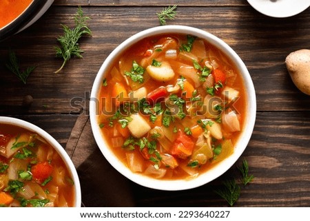 Cabbage soup in bowl over wooden background. Top view, flat lay
 Royalty-Free Stock Photo #2293640227