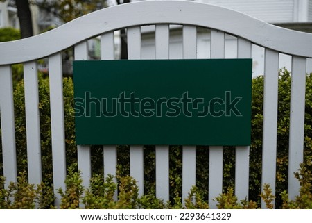 Horizontal green empty signage on wood fence shop front. High quality photo