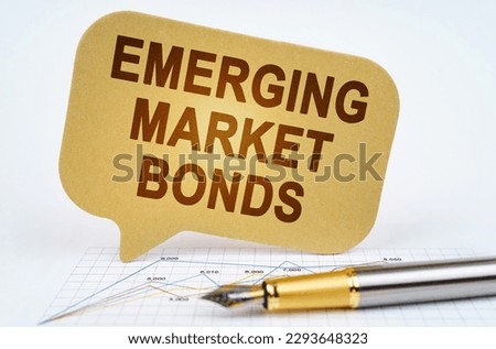 Business concept. On the business diagram is a pen and a sign with the inscription - emerging market bonds Royalty-Free Stock Photo #2293648323