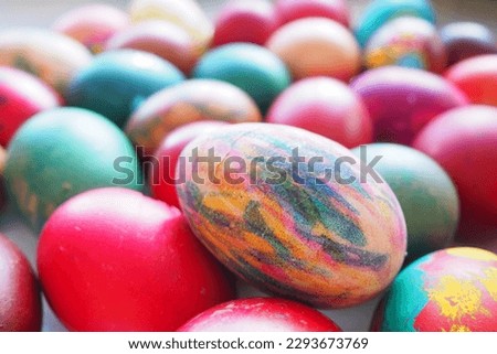 Easter colorful eggs. Boiled chicken dyed eggs with red, pink, blue, green, yellow, orange and brown shells. Large egg painted with felt-tip pens. Royalty-Free Stock Photo #2293673769