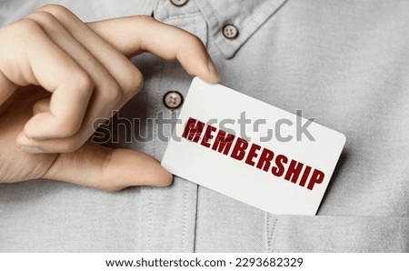 Man putting a card with text MEMBERSHIP in the pocket Royalty-Free Stock Photo #2293682329