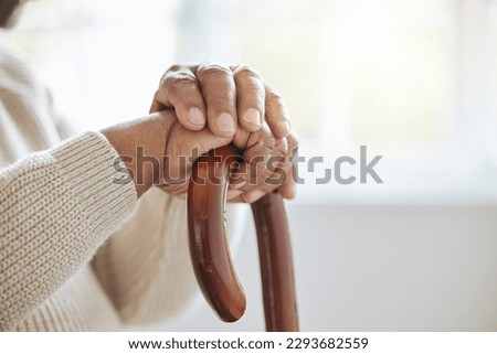 Waiting for another day. Shot of a senior man leaning in his walking stick at home. Royalty-Free Stock Photo #2293682559