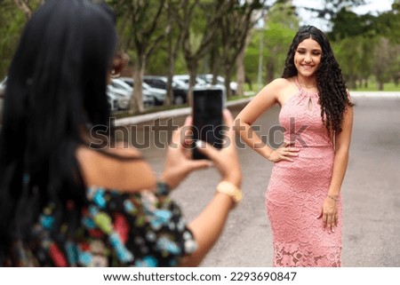 mother and daughter in the park, taking photo, mother's day