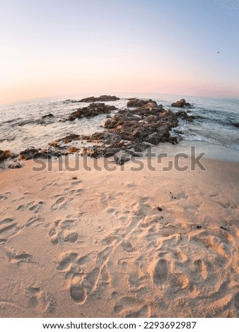 sunset on the beach with white sand and rocks