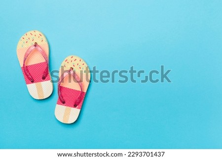 Bright flip flops on color background, top view Royalty-Free Stock Photo #2293701437