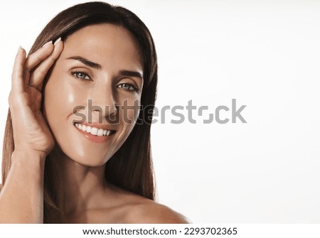 Smiling 40s years middle-aged woman with healthy, clear glowing skin, no wrinkles, using anti-aging beauty products, hyaluronic acid and nourishing creams for natural glow and lifting effect Royalty-Free Stock Photo #2293702365