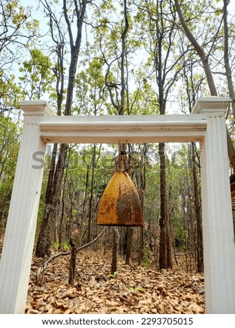 The old bell was in the forest.