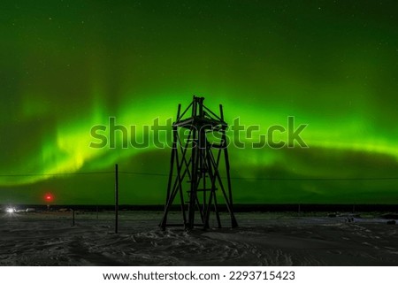 Northern lights (Aurora Borealis), a wooden tower of an old lighthouse, Murmansk region, White Sea, Far North, Russia