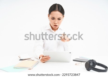 Angry korean woman shouting at employee on video chat, has intense conversation online, looks frustrated at digital tablet, white background.