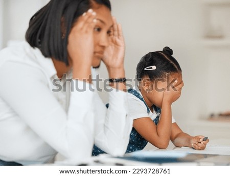 Im gonna lose it with this kid. Shot of a young mother looking frustrated while helping her daughter with homework at home.
