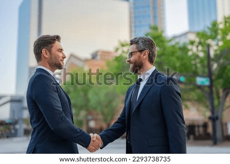Business man shaking hands. Two businessmen handshake outdoor. Handshake business people. Motivation and inspiration for the two business man. Two business men discussed their strategy. Royalty-Free Stock Photo #2293738735