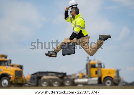 Fast building. Funny construction worker jumping. Excited jump of builders run in helmet. Worker in hardhat. Construction engineer in builder uniform run and jump. Excited foreman. Royalty-Free Stock Photo #2293738747