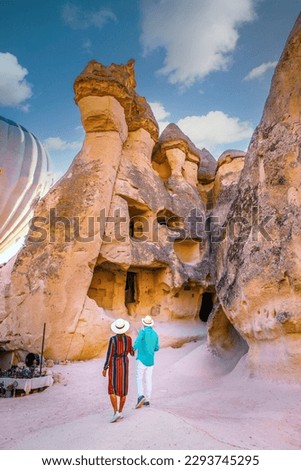 Turkey Cappadocia, a happy young couple of men and women on vacation in Turkey Cappadocia, Rock Formations in Pasabag Monks Valley, Cappadocia, Turkey