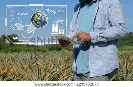 Sustainability in agricultural production, organic farming as an environmentally benign practice, and an emblem for ecology with a 3D globe and a farmer standing in an organic farm. Royalty-Free Stock Photo #2293752079