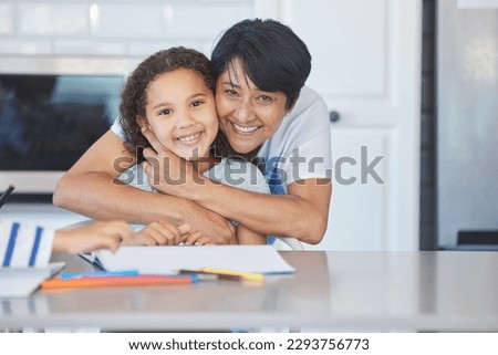 Look at her sweet face. Shot of a grandma helping her granddaughter at the kitchen table at home.