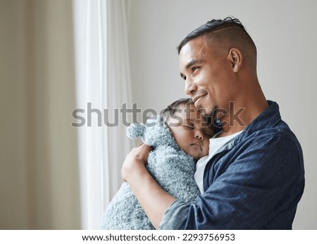 This is the best feeling. Shot of a young father embracing his baby at home. Royalty-Free Stock Photo #2293756953