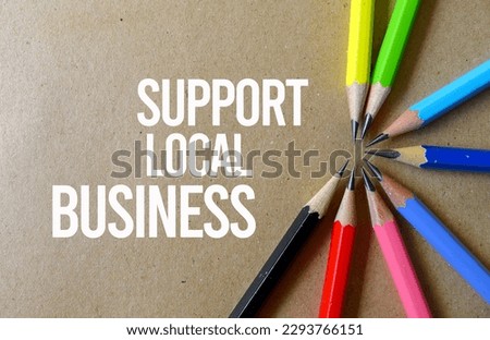 Support Local Business written on a isolated brown paper Royalty-Free Stock Photo #2293766151