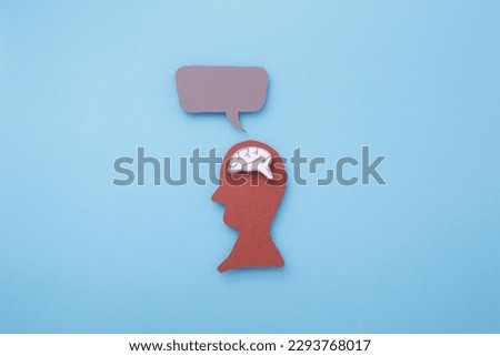 People with brains in their heads and idea box on head made of paper cut on blue background.