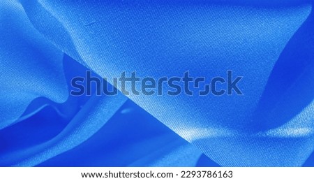 blue silk fabric, smooth satin fabric in sapphire shades. Texture, background, pattern