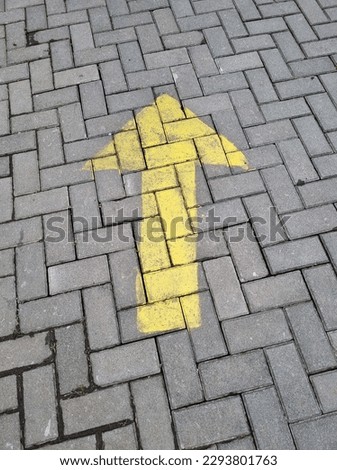 yellow arrow sign at the abstract floor