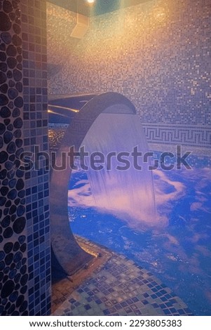 Pool with illumination and waterfall, entrance to the sauna, the concept of hardening of health, walrus. 