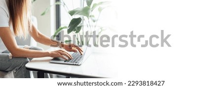Selective focus of Young woman holding credit card and using laptop computer. Online shopping, e-commerce, internet banking, spending money, working from home concept