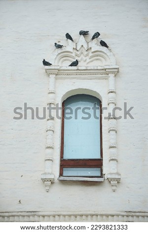 The window of an old brick building, the Middle Ages. Architectural elements of castles and churches