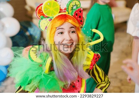 a young woman in a stage costume works as an animator at a children's party. entertainment for children.