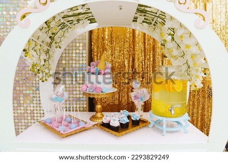 candy bar with lemonade, desserts and multicolored cake decorated with cakes and waffle cone. the concept of birthday traditions.