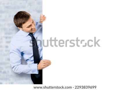 Portrait image of business man professional bank manager in confident cloth, tie. Businessman stand behind look at empty white banner signboard with copy space area. White bricks wall background